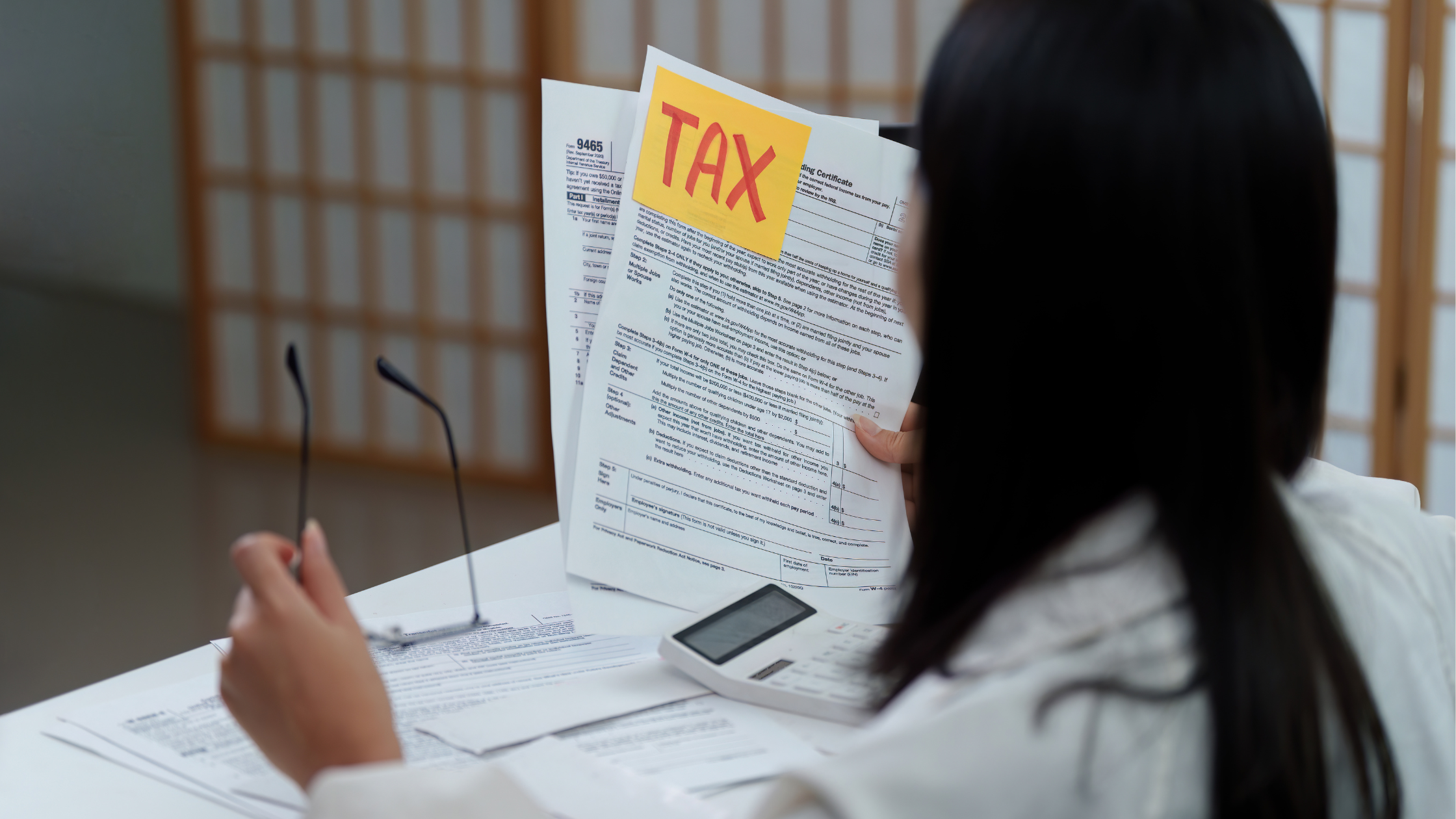 Girl holding up tax forms